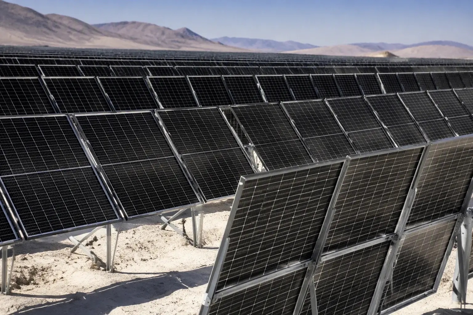 HJT bifacial array in a desert with white sand reflecting light onto panel backsides